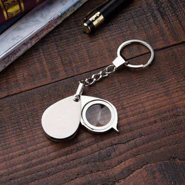Folding pocket magnifying glass for stamps, coins, and travel